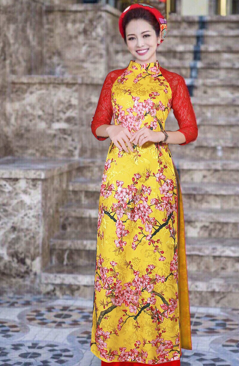 Áo dài truyền thống màu vàng họa tiết hoa đào phối tay ren đỏ